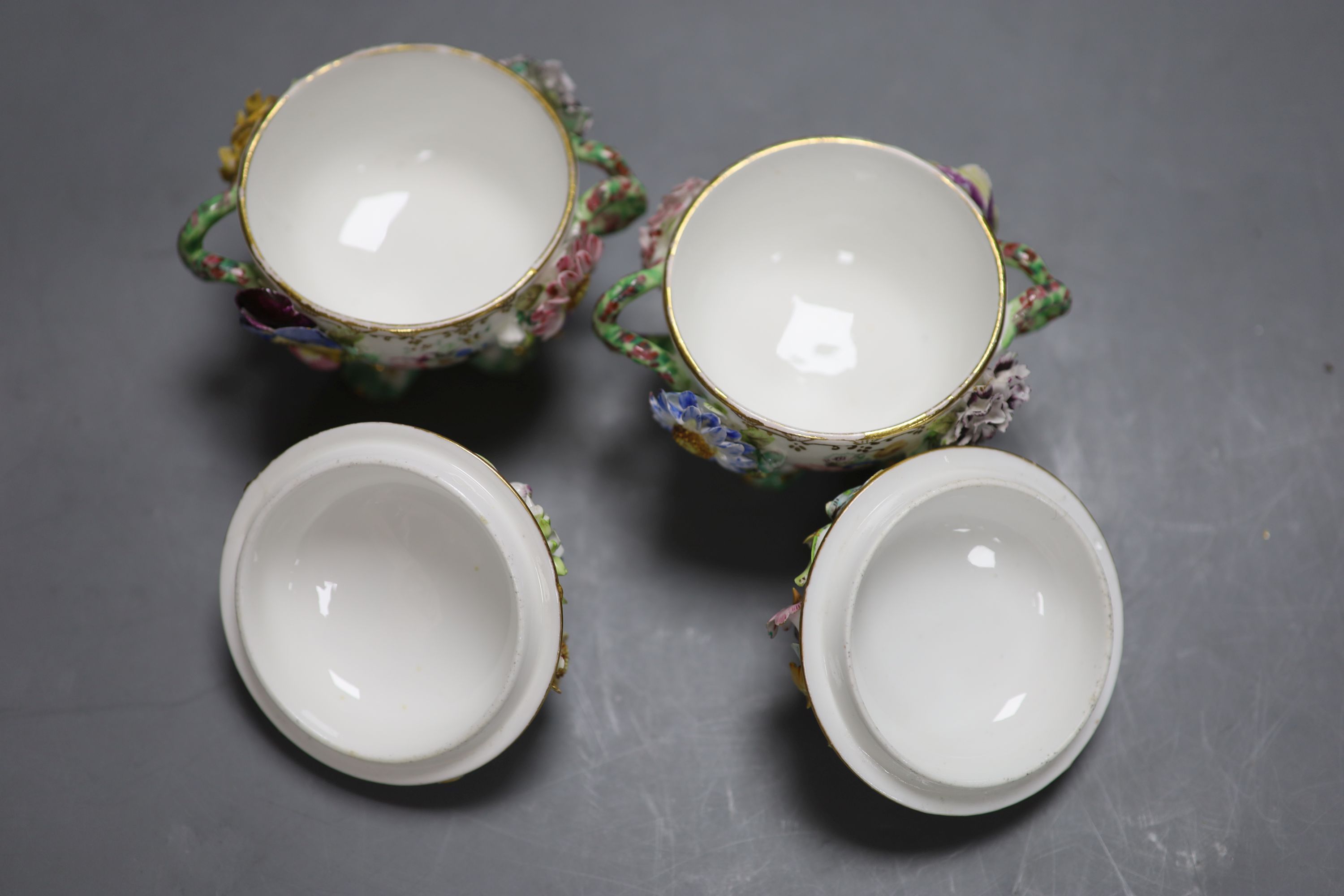 A mid 19th century Coalport pair of floral encrusted two handled cups and covers